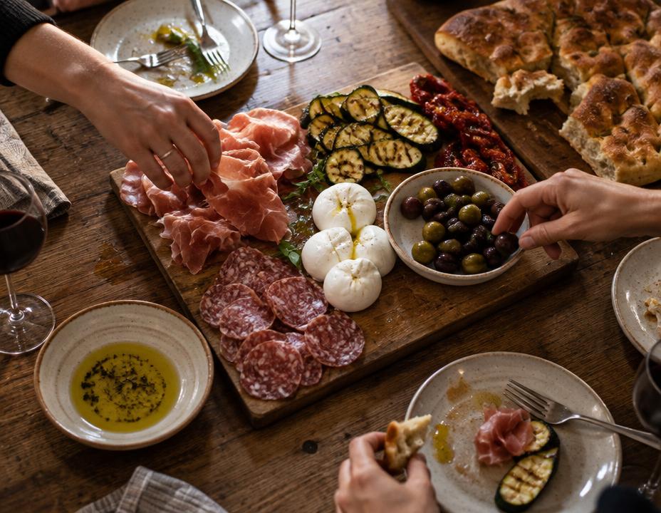 An antipasti board of prosciutto, olives and mozzarella